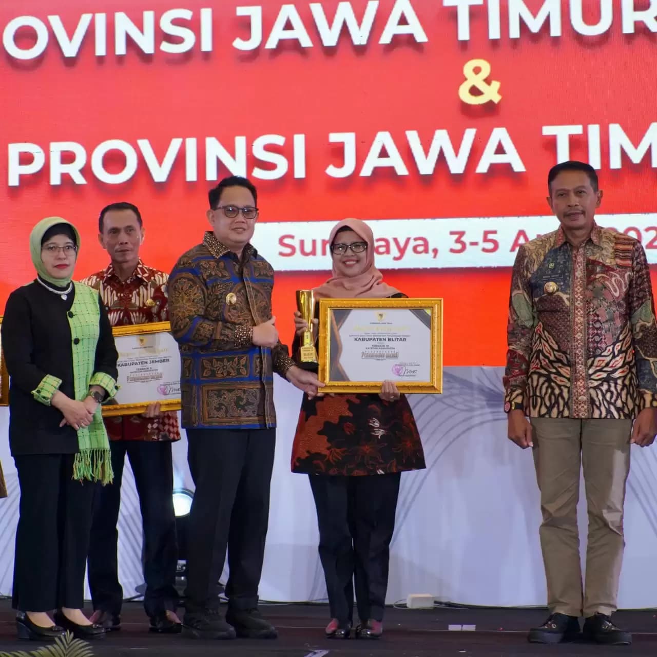 Pj. Gubernur Jawa Timur, Adhy Karyono, menyerahkan penghargaan kepada Bupati Blitar Rini Syarifah