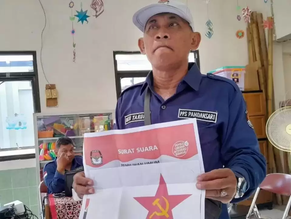 Petugas PPS Kelurahan Pandansari, Kota Semarang, menunjukkan temuan surat suara pemilu yang ditempel secarik kertas bergambar palu arit, Rabu (14/2) (Foto: Antara)